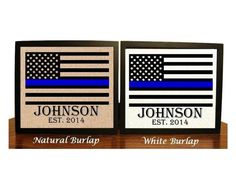 two plaques with blue and white stripes on them, one has an american flag in the middle