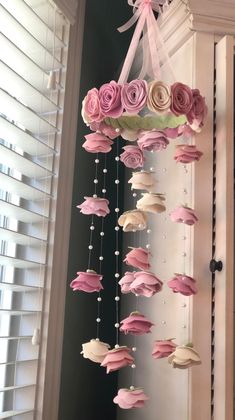 pink and white flowers are hanging from the ceiling