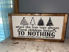 a wooden sign that says where the tree tops glisten and children listen to nothing