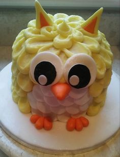 a cake that looks like an owl with yellow icing on it's face