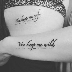 two women with tattoos on their backs saying you keep me safe, you keep me wild