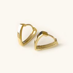 One pair of cool and modern hoop earrings handcrafted in 14K solid gold. The Triangle shape gives basic hoops a fresh new look. Ships within 3 business days. - Earring size: 12mm - Earring width: 2.5mm - Inner diameter: 10mm - Sold as A Pair. - Made in 14 karat gold. - Stamp with 14K. Gold Bali Earrings Indian Small, Minimalist Gold-plated Huggie Earrings, Minimalist Gold Plated Huggie Earrings, Gold Minimalist Huggie Earrings With Polished Finish, Modern Yellow Gold Huggie Earrings For Everyday, Modern Gold Plated Hoop Earrings For Everyday, Modern Everyday Gold Plated Hoop Earrings, Modern Gold-plated Hoop Earrings For Everyday, Minimalist Gold Plated Pierced Huggie Earrings