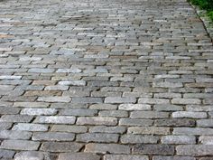 an image of a brick road that looks like it is going to be paved with grass