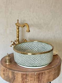 a bathroom sink sitting on top of a wooden table next to a faucet