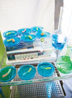 the books are stacked on top of each other in front of some glasses and water bottles