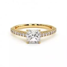 a yellow gold ring with a princess cut diamond