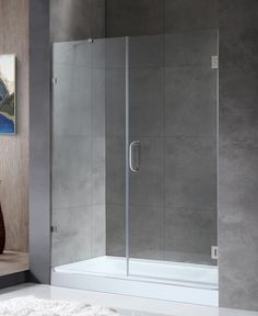 a bathroom with a glass shower door and rug on the floor