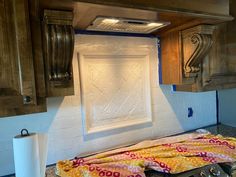 a stove top oven sitting inside of a kitchen next to wooden cabinets and counter tops