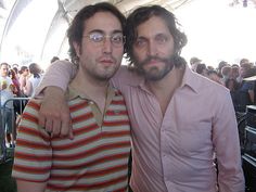 two men standing next to each other in front of an audience at a music festival