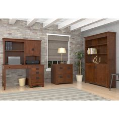 a living room scene with focus on the desk and bookcases, along with an area rug