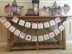 an american flag bunting banner on a wooden table with candles and other patriotic decorations