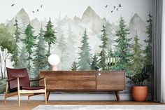 a living room with a wall mural that has trees painted on it