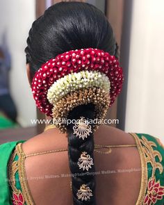 the back of a woman's head with beads on it