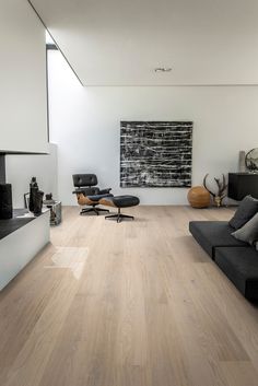 a modern living room with white walls and wood floors