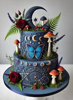 a three tiered cake decorated with mushrooms and flowers on a table next to a white wall