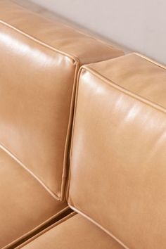 the corner of a tan leather couch