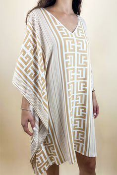 The ultimate beach cover up. With cascading bell sleeves and a stunning meandros print, this dress embodies a true air of a Grecian summer. Can easily thrown over a bathing suit for a look that is endlessly chic. One size fits all.Bust: 31 inches, Length: 34 inches, Shoulders: 21 inches100% Cotton. Made in Greece. V-neck Dresses With Geometric Pattern For Beach, Chic Printed V-neck Kaftan, Patterned Kaftan For Summer Beach Cover-up, Bohemian Maxi Dress With Geometric Pattern For Beach, Summer Beach Maxi Dress With Geometric Pattern, Geometric Pattern Dress For Summer Vacation, Elegant Batwing Sleeve Maxi Dress For Summer, Patterned Beachwear Maxi Dress For Beach, Patterned Maxi Beach Dress