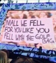 a group of people standing in front of a sign that says, nail we fell for you like you fell with the golf bag