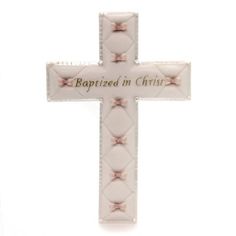 a white cross with pink bows and the words baptisted in christ written on it