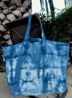 Upgrade your shopping experience with our Large IKEA Canvas Tote Bag, hand-dyed with natural Indigo dye. Measuring 24 x 17 x 8.5 inches, this spacious tote is ideal for grocery shopping, beach trips, or carrying your daily essentials. The vibrant tie-dye pattern makes this bag unique and stylish. Crafted from sturdy canvas, it features durable handles and a roomy interior. Choose this eco-friendly, versatile tote for your everyday needs. Care:  All fabrics are dyed using professional grade dyes, Ikea Canvas, Natural Indigo Dye, Reusable Gift Bags, Indigo Dye, Tie Dye Patterns, Canvas Tote Bag, Shibori, Beach Trip, Sacramento