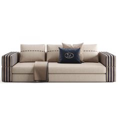 a beige couch with blue and white pillows on it's back end, facing away from the camera