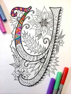 a coloring page with an elephant's head and feathers in the center, surrounded by markers