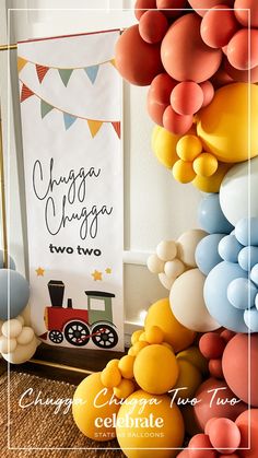 balloons are arranged in the shape of a train and balloon arch for a birthday party