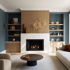 a living room with blue walls and a fire place in the center, surrounded by furniture