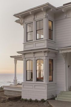 an image of a white house with windows on the front and side of it that says, a room with a view