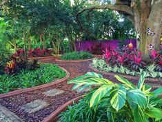 the garden is full of colorful flowers and trees