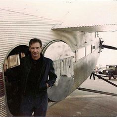 a man standing in front of an airplane