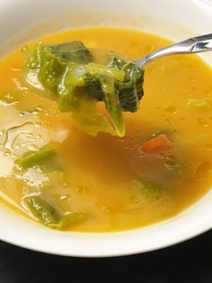 a spoonful of soup with broccoli and carrots