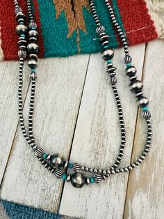 New without tags BRAND : Nizhoni Traders LLC ETHNIC & REGIONAL STYLE : Native American TYPE : Beads JEWELRY TYPE : Necklaces STYLE : Beaded METAL : Sterling Silver TRIBAL AFFILIATION : Navajo COUNTRY/REGION OF MANUFACTURE : United States COUNTRY OF ORIGIN : USA MAIN STONE : Turquoise Beautiful Navajo Sterling Silver Pearl and Turquoise Beaded Necklace. Measures 60 inches long. Perfect by its self or with your favorite pendant. Great for any collection! Thank you for looking at our items. Please Necklaces Style, Turquoise Beaded Necklace, Turquoise Bead Necklaces, Blowout Sale, Pendant Rings, Beads Jewelry, Turquoise Beads, Silver Pearls, Turquoise Necklace