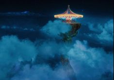 an amusement park in the clouds at night