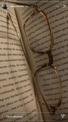 an open book with glasses on top of it and the caption's page below