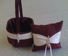 two brown and white wedding baskets on the floor next to each other, one holding a ring