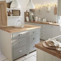 a kitchen with lots of counter space and lights on the wall over the stove top