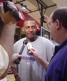 a man holding a microphone talking to someone