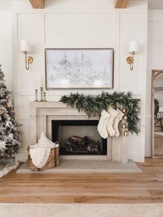 a living room decorated for christmas with stockings on the fireplace