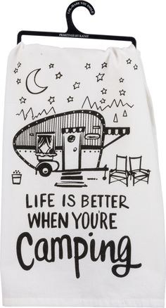 a tea towel hanging on a rack with the words life is better when you're camping