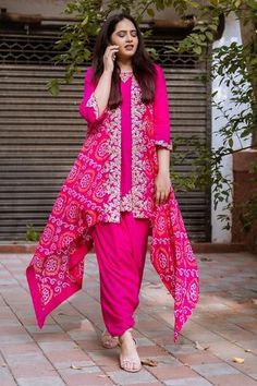 Pink kurta with gota embroidered motifs. Comes with draped pant and long jacket.
Component: 3
Embroidery
Neckine: Kurta: Round
Sleeve Length: Kurta: Three fourth; Jacket: Sleeveless
Fabric: Kurta and Pant: Silk Linen Matka; Dupatta: Georgette
Color: Pink
Hand embroidery
Bandhani motifs and gota embroidered motifs on jacket
Asymmetric hem on jacket - Aza Fashions Bandhej Outfit Ideas, Bandhani Saree Outfit, Badhni Saree Blouse Design, Bandini Dress Designs, Bandhni Dress Design, Bandhani Short Kurti, Bandhani Designs Pattern, Bandej Dress Indian, Bandhani Dress Design Patterns