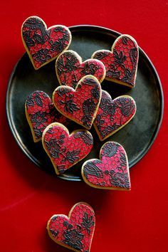 heart shaped cookies on a black plate