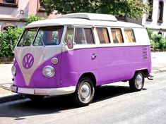 an old vw bus is parked on the side of the road