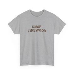 Inspired by the iconic summer camp in the cult classic movie Wet Hot American Summer. This vintage-style t-shirt features the classic Camp Firewood logo on a soft, comfortable fabric that will make you feel like you're ready to hit the bunk beds and relive those summer camp memories. Whether you're a die-hard fan of the movie or just love the retro camp aesthetic, this t-shirt is the perfect addition to your wardrobe. So grab your bug spray and your s'mores, and get ready to channel your inner camp counselor in style with the Camp Firewood t-shirt. .: 100% cotton.: Classic fit.: Tear-away label.: Runs true to size S M L XL 2XL 3XL Width, in 17.99 20.00 21.97 23.98 25.98 27.99 Length, in 28.00 29.00 30.00 31.00 32.00 33.00 Sleeve length (from center back), in 15.75 16.93 18.50 20.08 21.65 2 Summer Camping Graphic Tee, Summer Graphic Tee For Camping, Graphic Tee With Text Print For Camping, Pre-shrunk Cotton Camp Shirt For Camping, Cotton T-shirt With Text Print For Camping, Cotton T-shirt With Letter Print For Camping, Camping Cotton T-shirt With Screen Print, Camping Cotton Screen Print T-shirt, Cotton Screen Print T-shirt For Camping