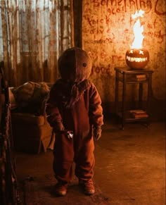 a little boy standing in front of a fire