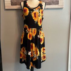 Nwot You Will Love This Adorable Sunflower Swing Sundress! Black With Beautiful Sunflowers Yellow/Red/Green/White Two Side Pockets Size L Super Soft And Lightweight Material Is Gorgeous Sleeveless Scoop Neckline Scoop Bottom Elastic Waistline Stretchy Pit To Pit 20” Length 38” Please See All Photos Color May Appear Slightly Different Due To Lighting 0687 Sundress Black, Beautiful Sunflowers, Photo Colour, Scoop Neckline, Yellow White, Red Green, Sundress, Sunflower, Red And White