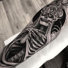 a man with a skeleton tattoo on his arm