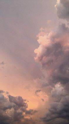 an airplane is flying through the cloudy sky