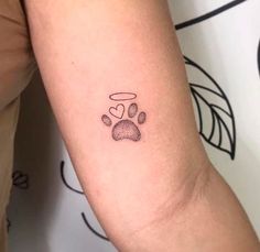 a small paw print on the arm with a heart and dog's paw prints