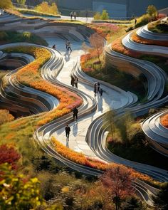 several people are walking down a winding road